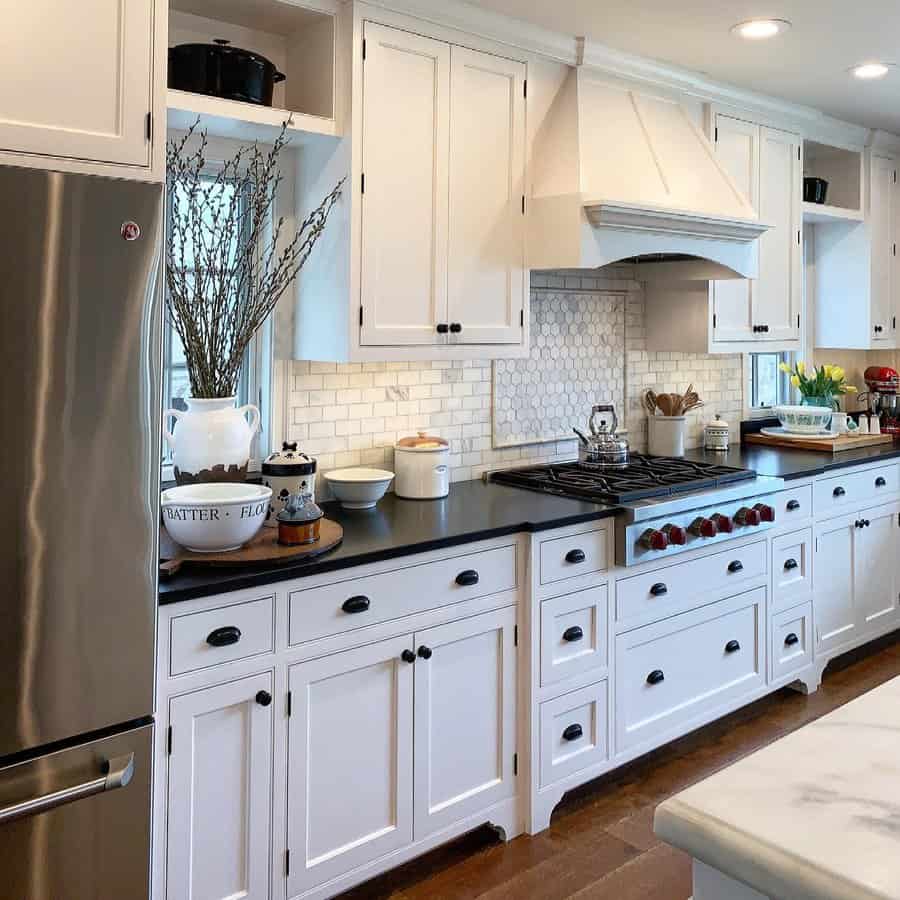 White cabinets with black countertops