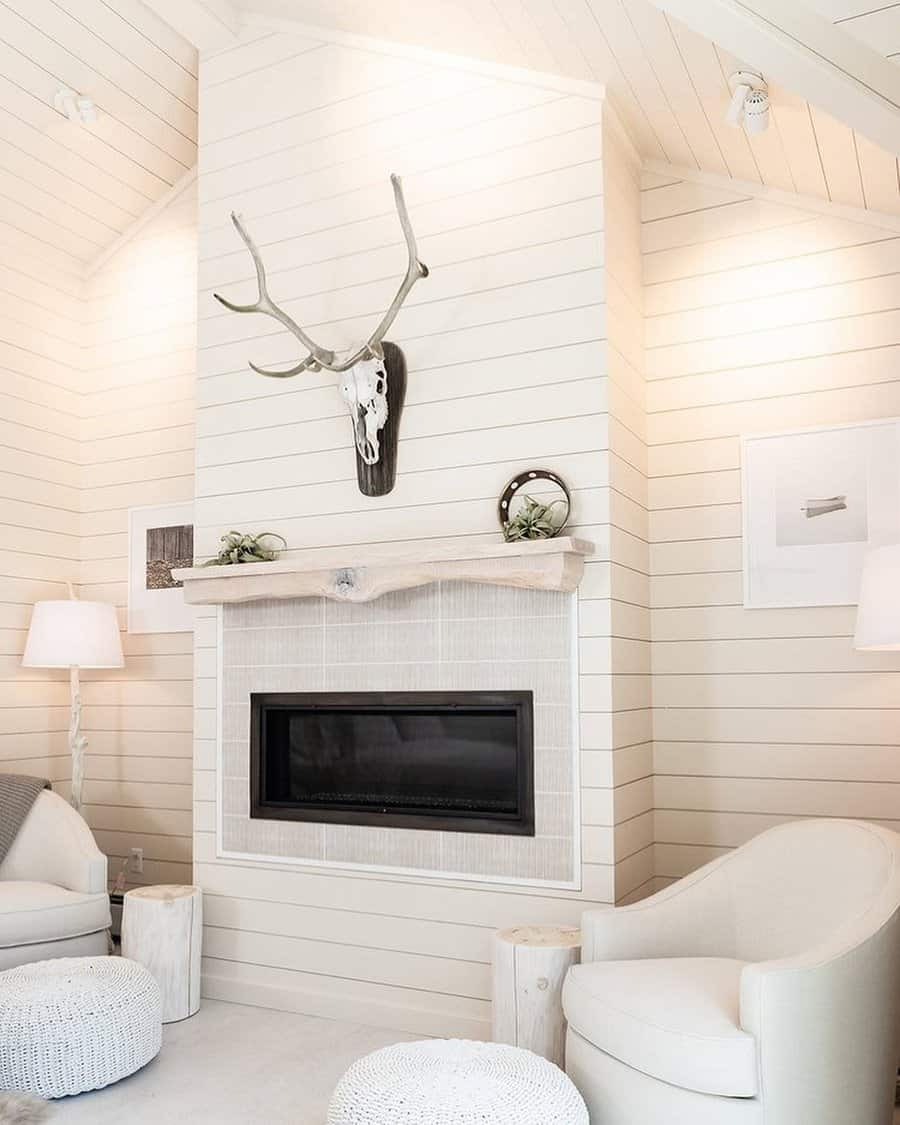 Bright living space with white shiplap and antler decor