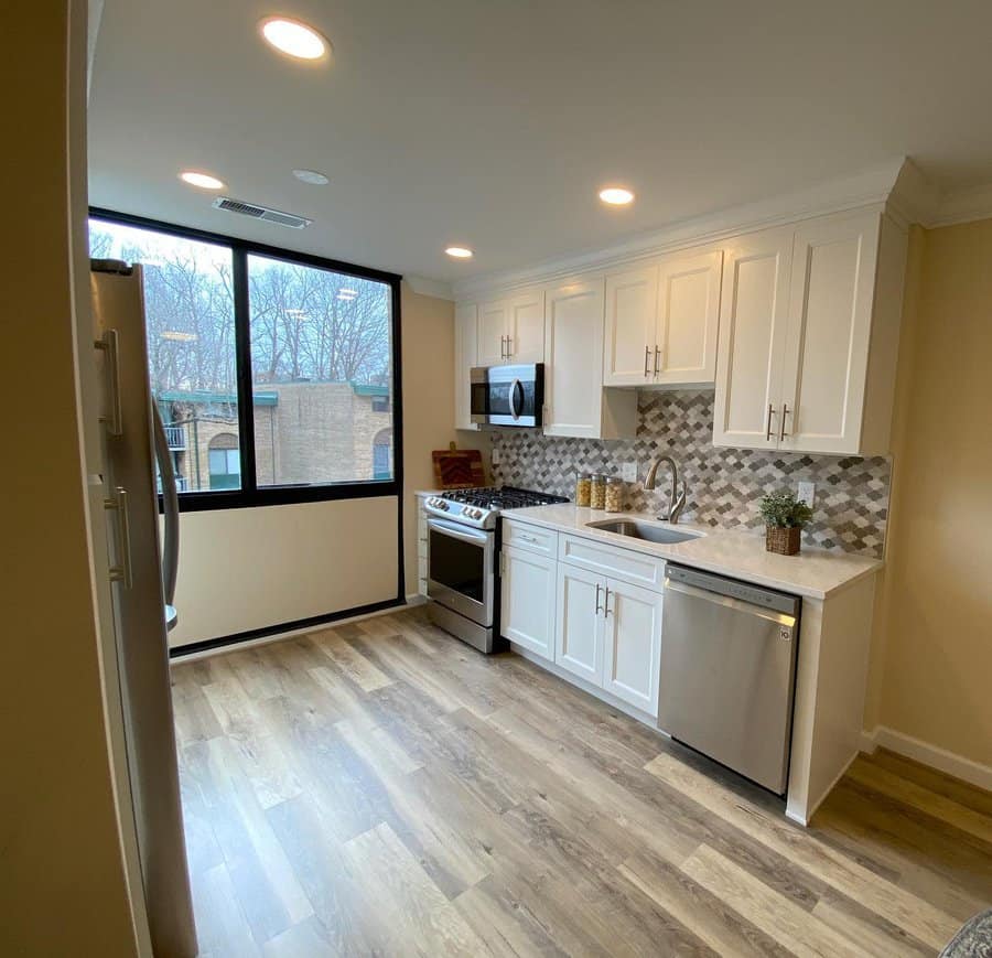 Bright kitchen with patterned backsplash and large window