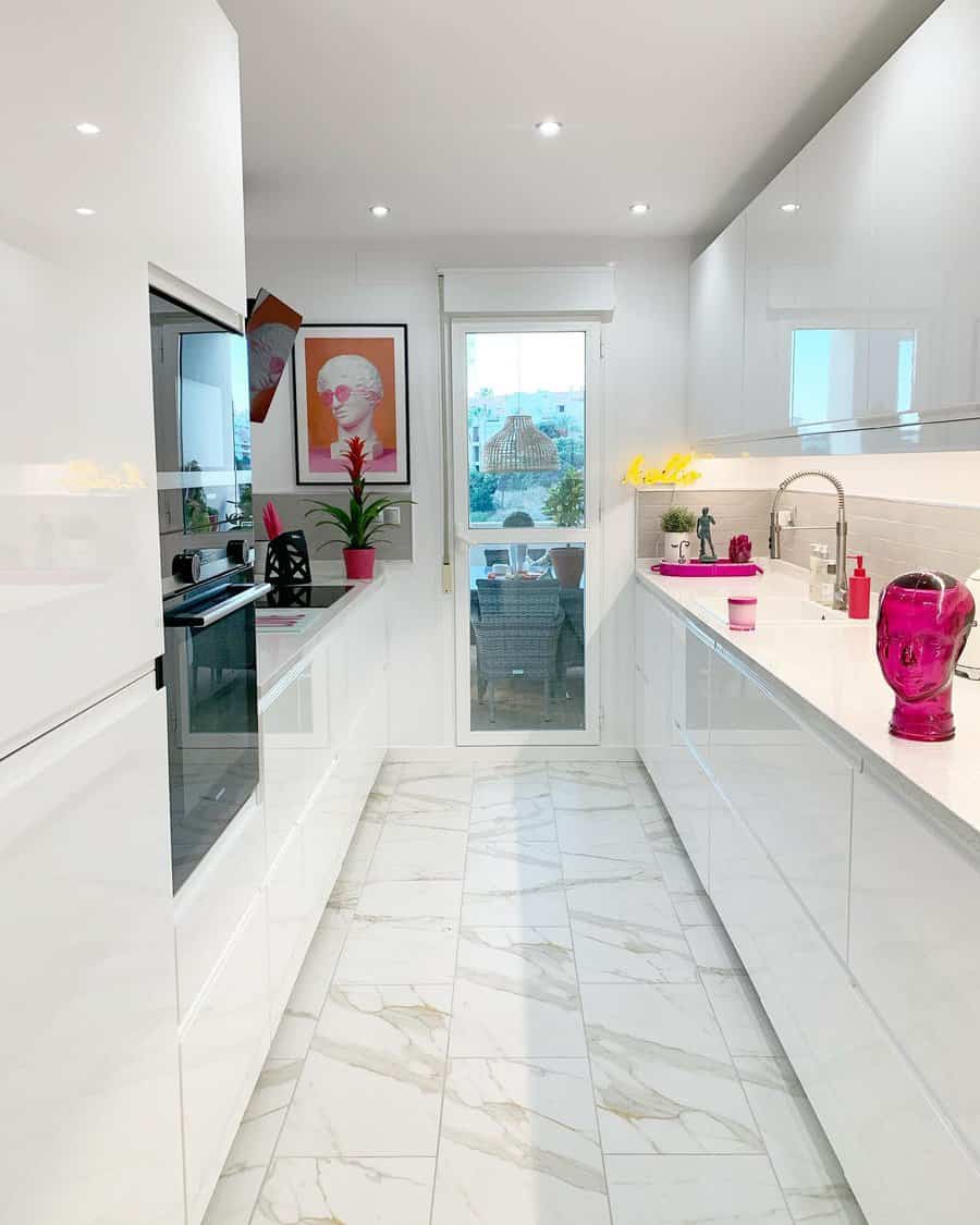 White glossy kitchen with pops of pink decor