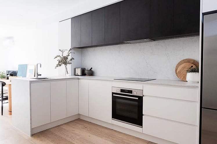 Minimalist kitchen with contrasting cabinets and countertops