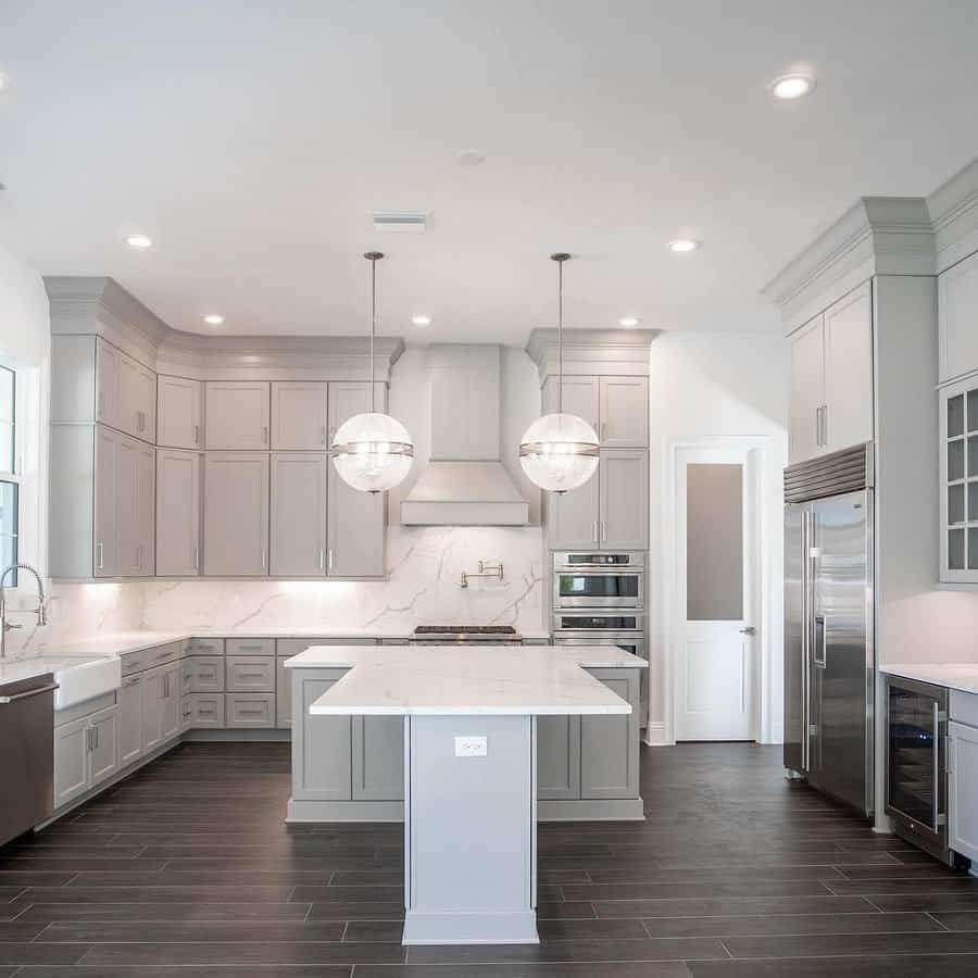 Spacious kitchen with elegant gray cabinetry and white countertop