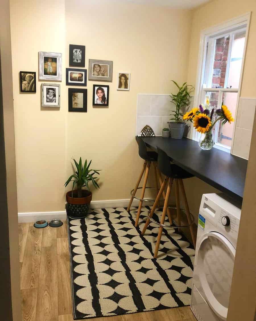 Cozy window breakfast bar with a sleek black countertop, modern barstools, warm decor, and vibrant sunflowers adding a cheerful touch