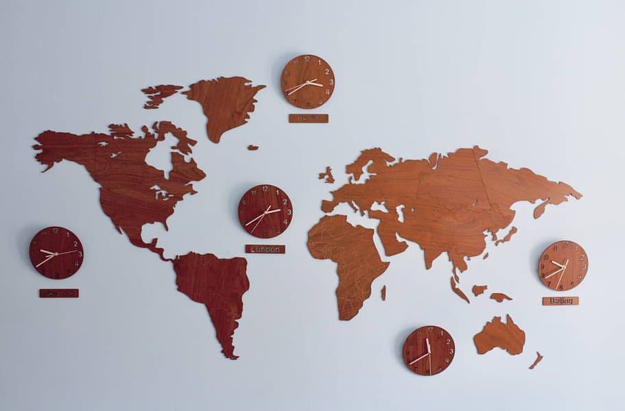 World map crafted from wood and with clocks