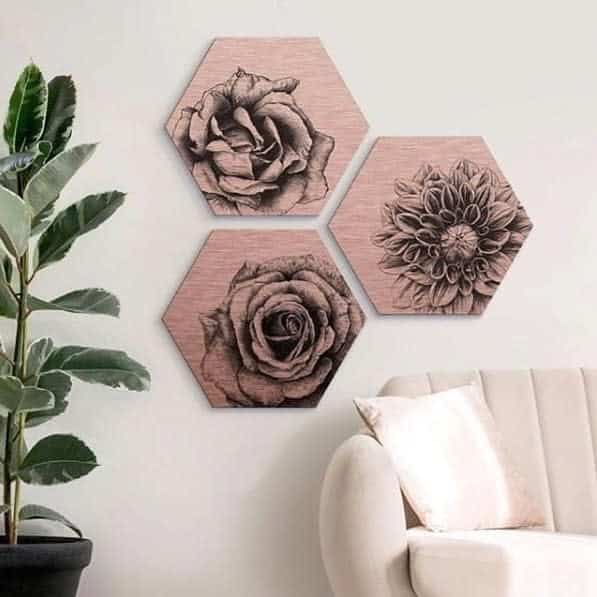 Three wooden hexagons adorned with flowers hung on the wall