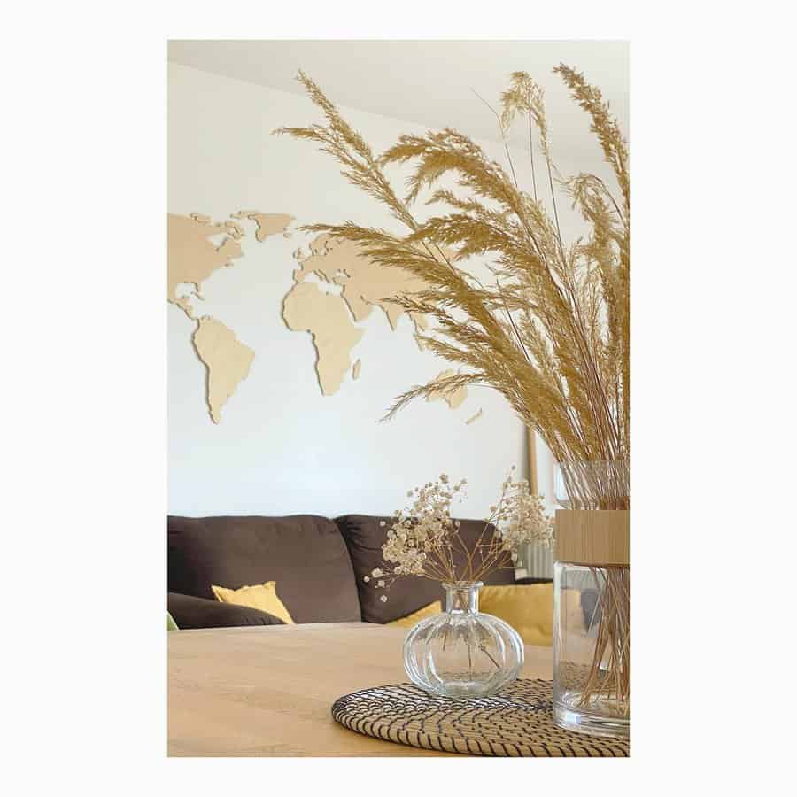 Decorative vase with dried grass and world map backdrop