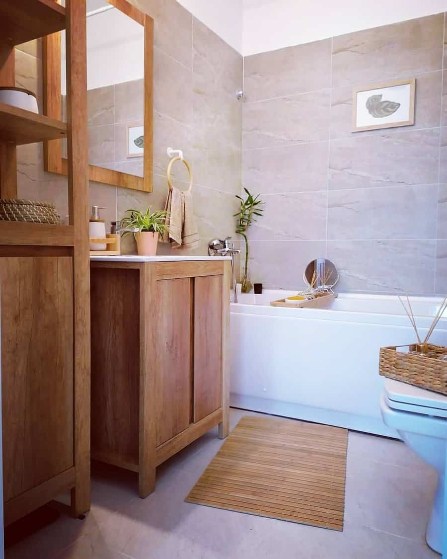 Natural wood bathroom vanity with large mirror and beige tiles