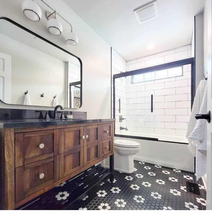 Modern farmhouse bathroom with wood vanity and black accents