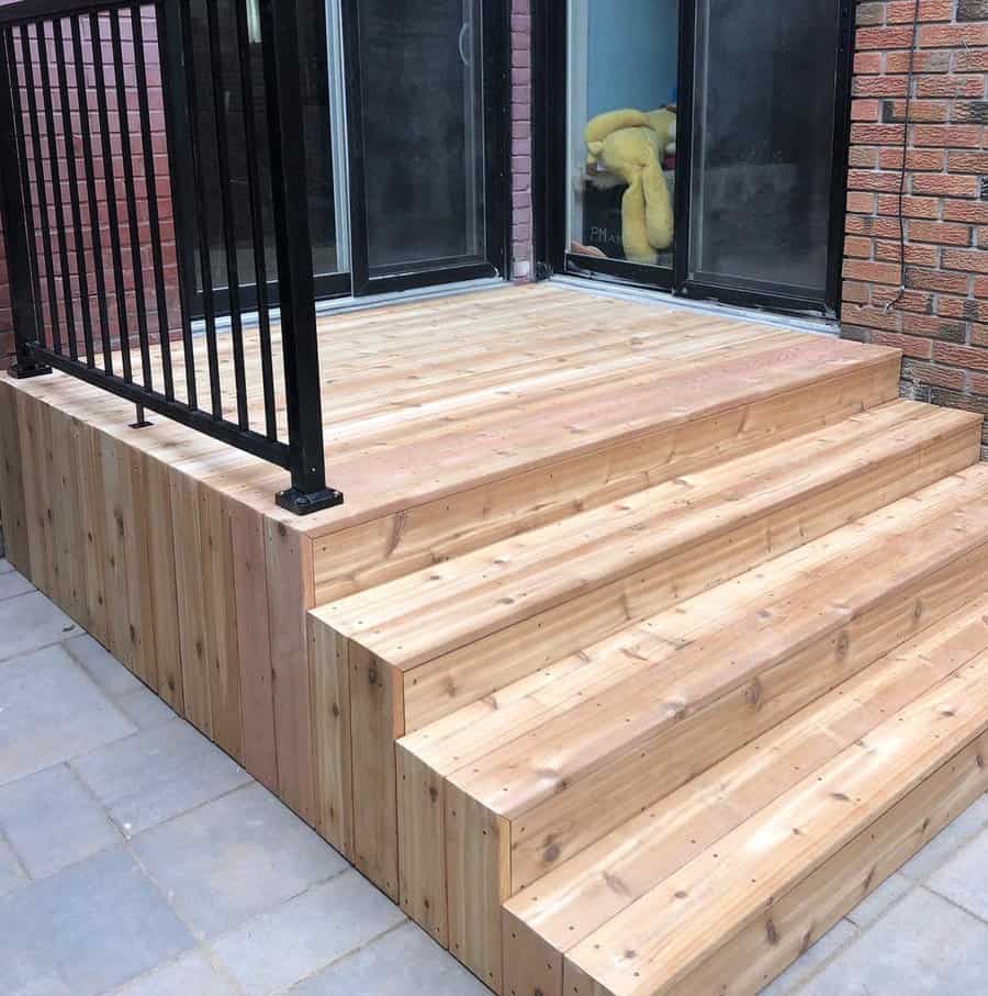 New wooden deck with steps and metal railings