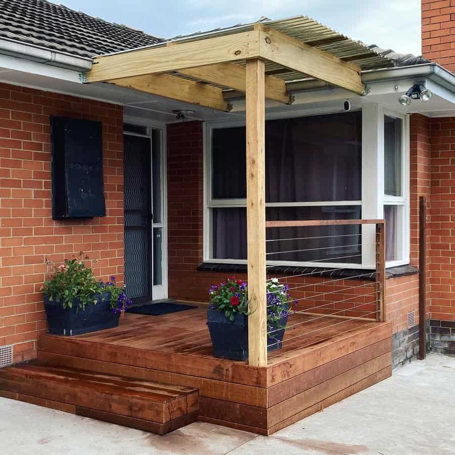 Covered porch with wooden deck and cable railing