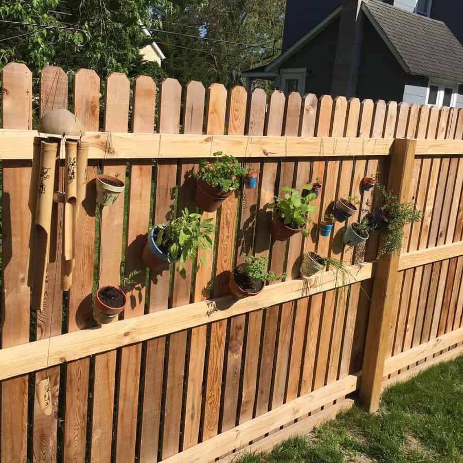 Wooden fence with hanging plants 