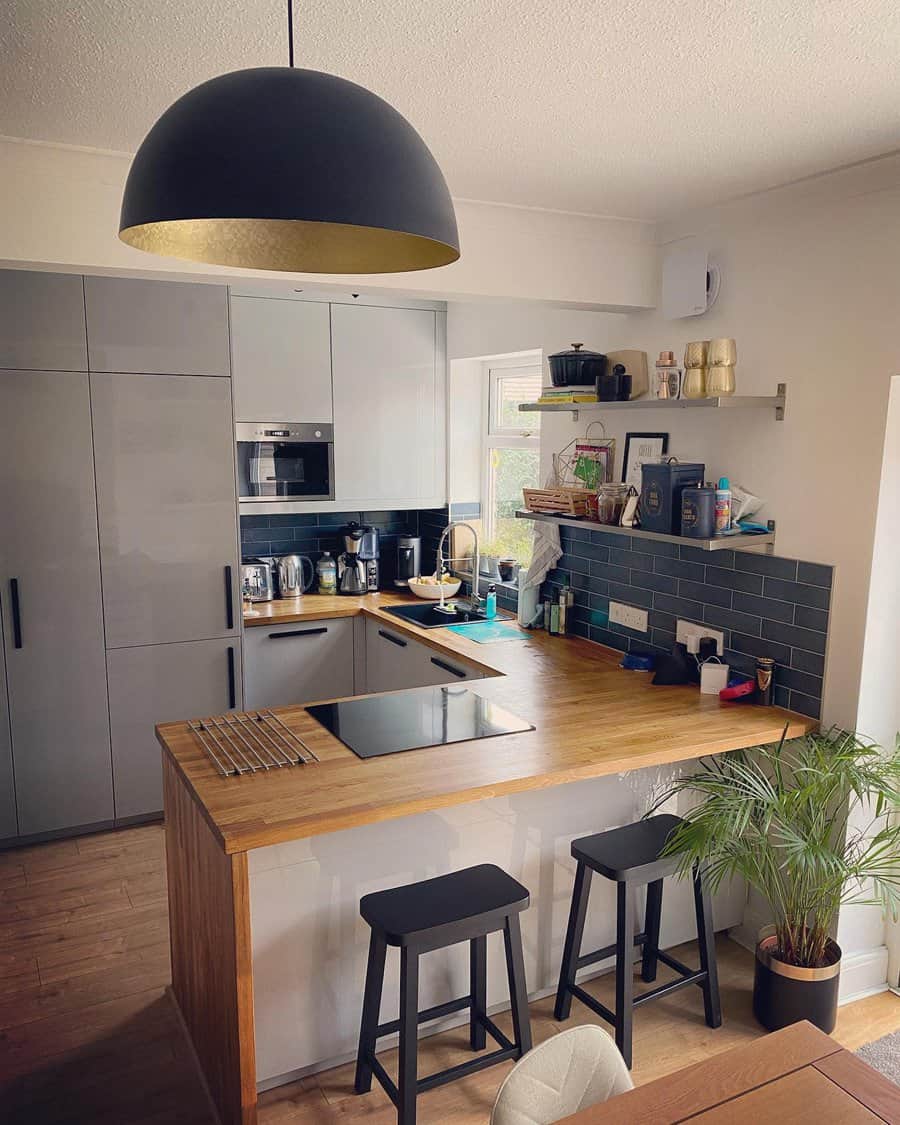 Cozy kitchen bar with wooden stools and pendant lighting