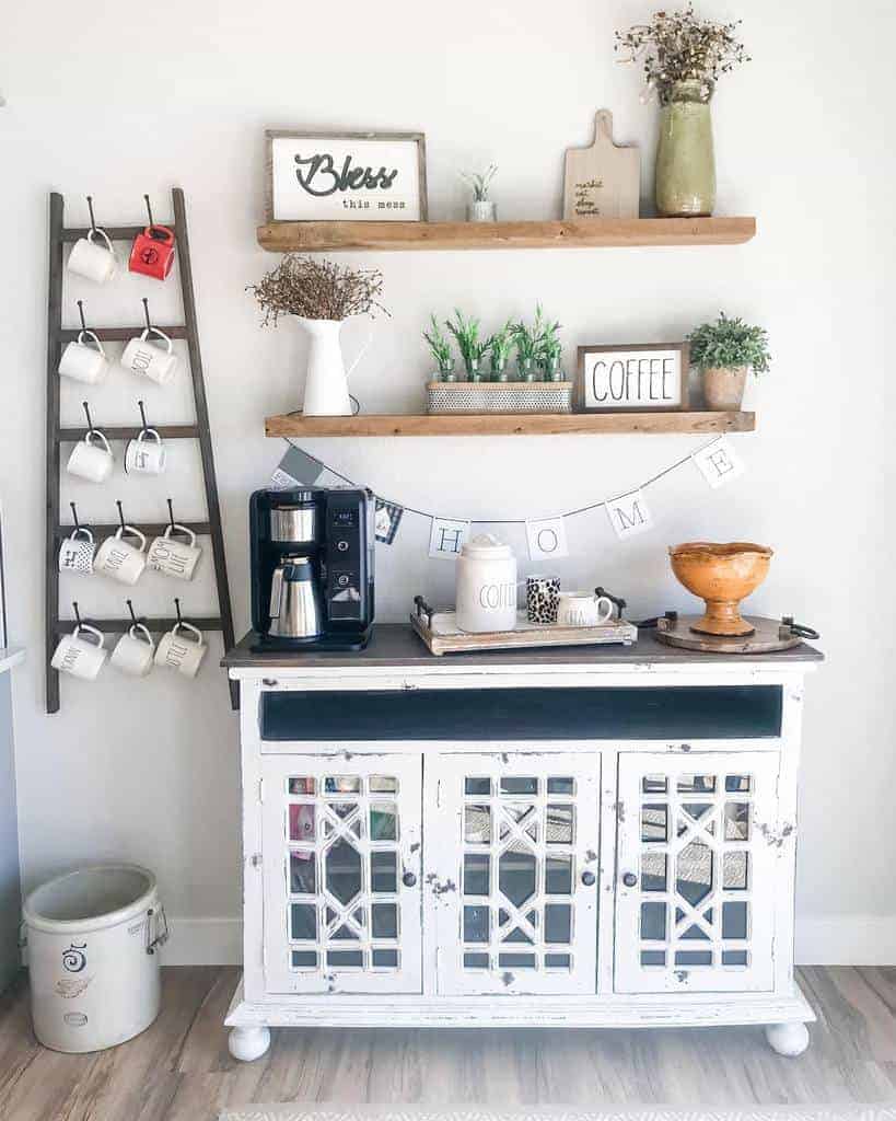 Rustic coffee station with wooden floating shelves, a vintage cabinet, mug ladder, and farmhouse decor for a cozy kitchen setup