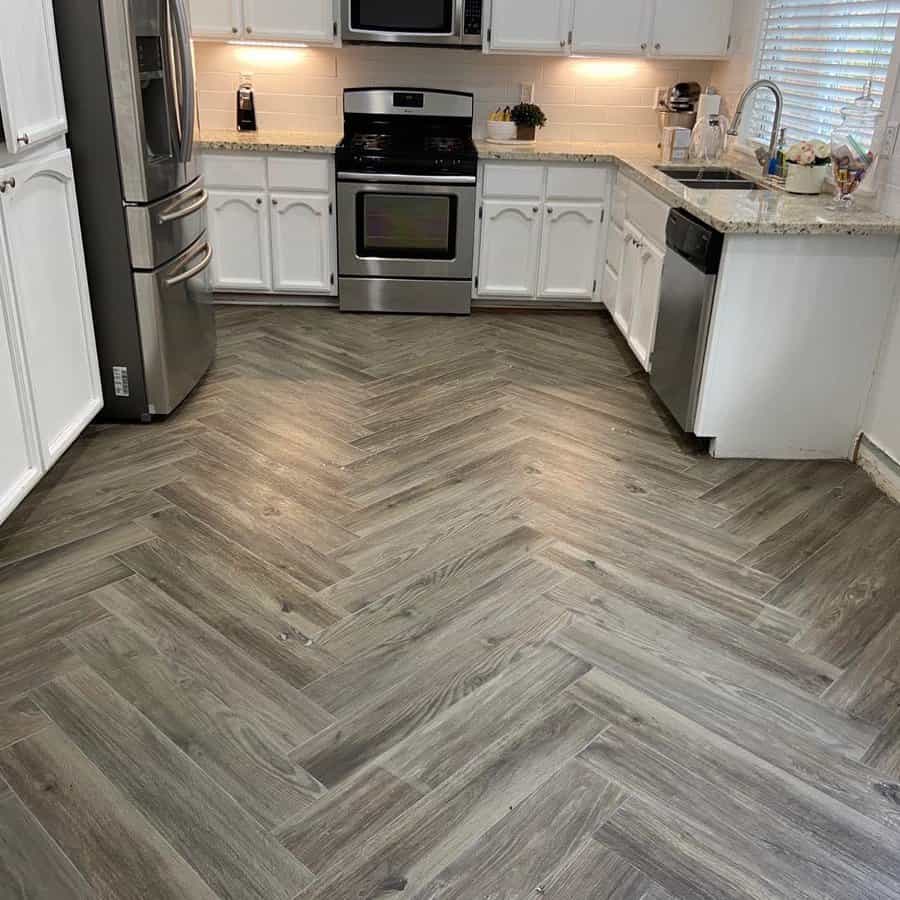 Kitchen with white cabinets and gray herringbone floor