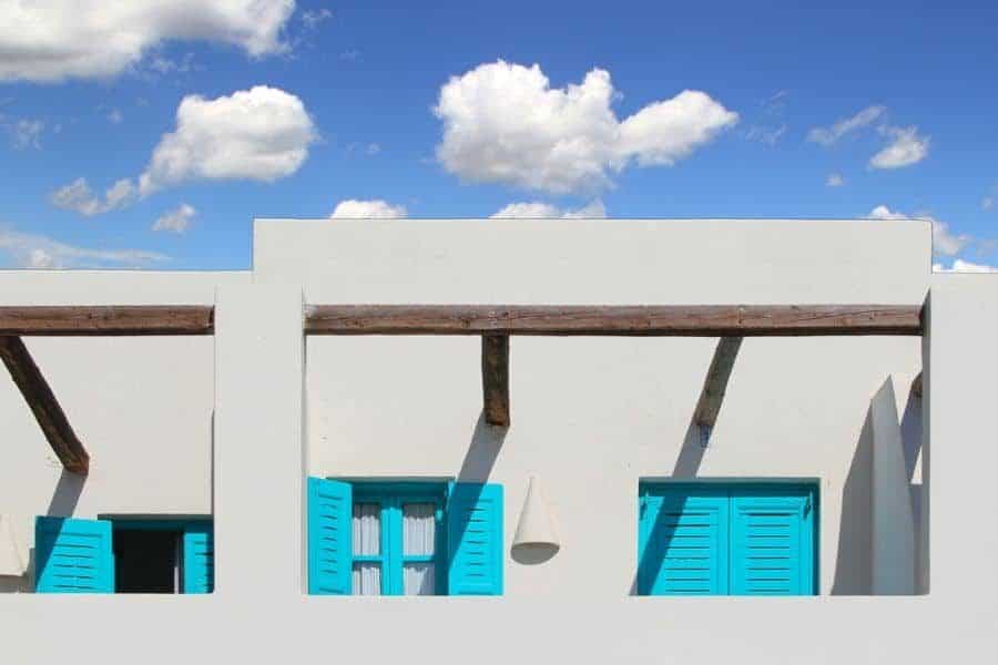 White mediterranean house with blue windows