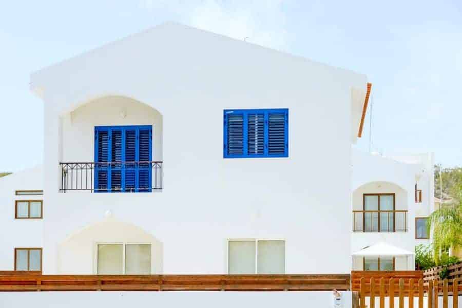 White mediterranean house with blue windows