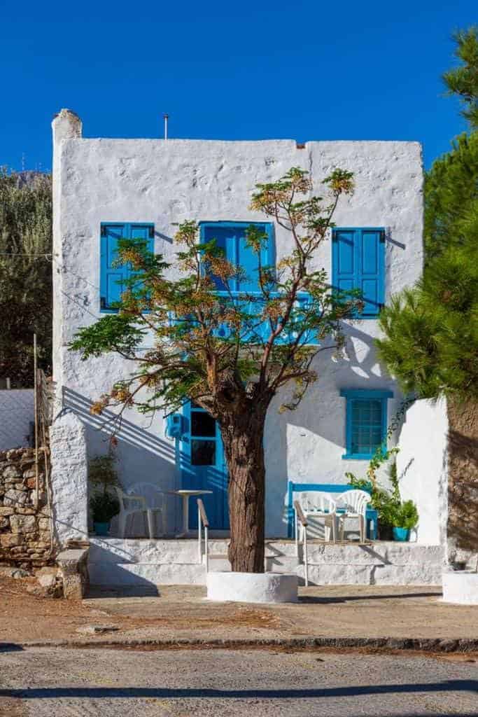 White mediterranean house with blue windows