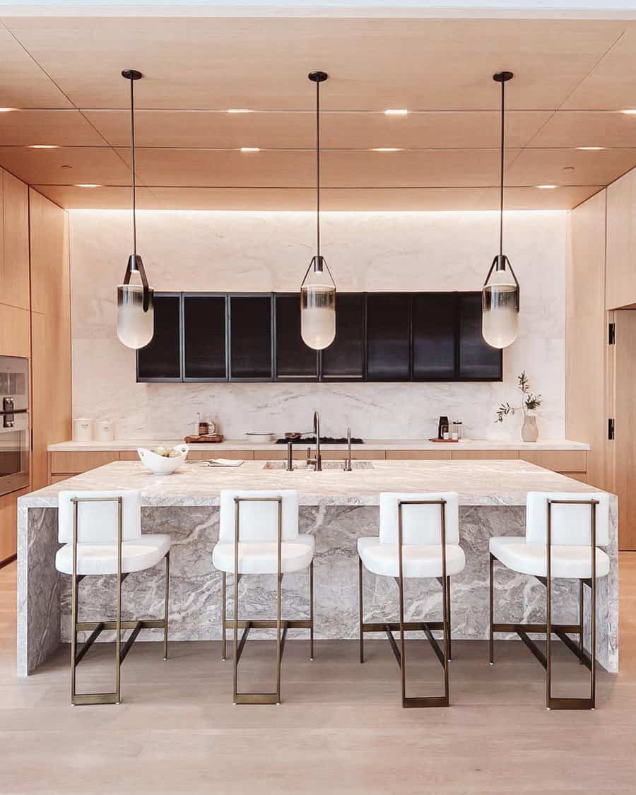 Chic kitchen with marble island and white chairs