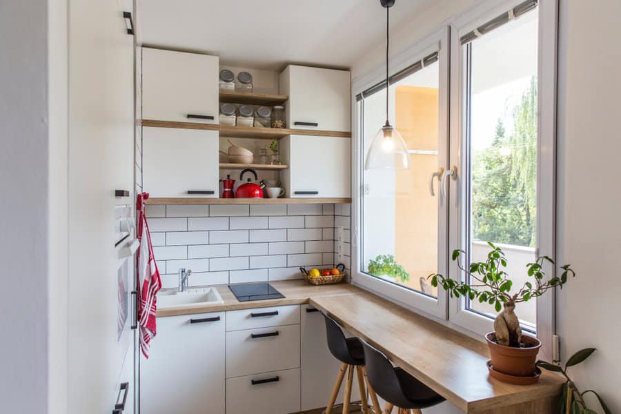 Bright kitchen corner with subway tiles and wooden table