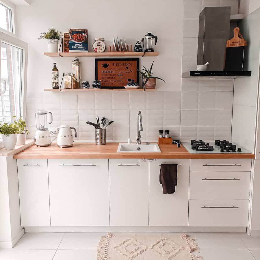 Cozy kitchen with white cabinets and wooden countertop