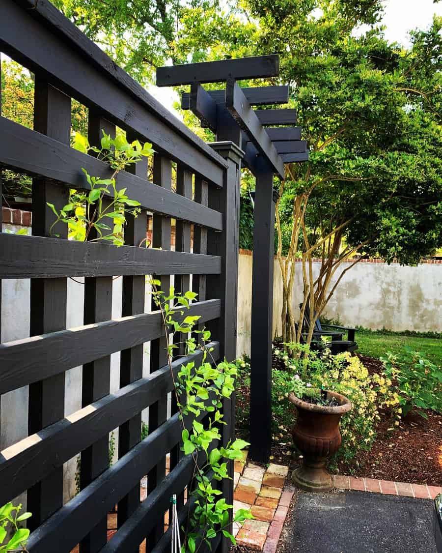 Modern black arbor with lattice and garden view