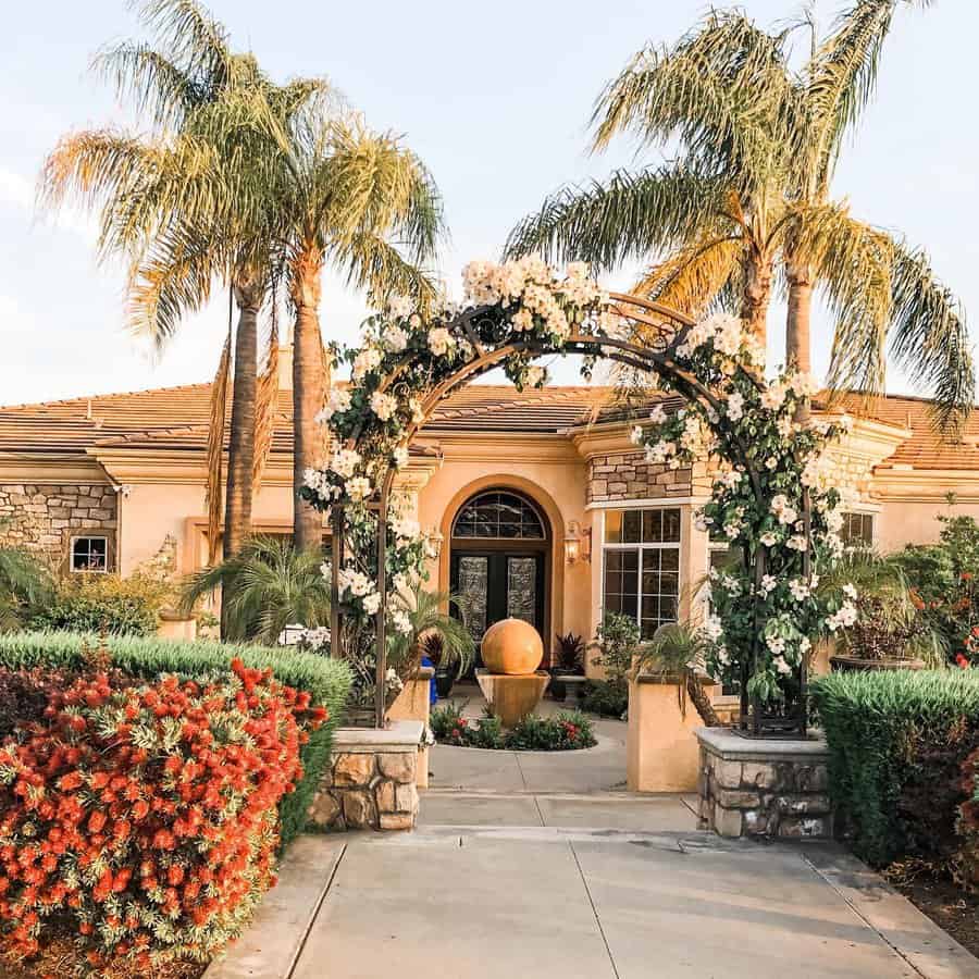 Arched trellis with flowers at house entrance