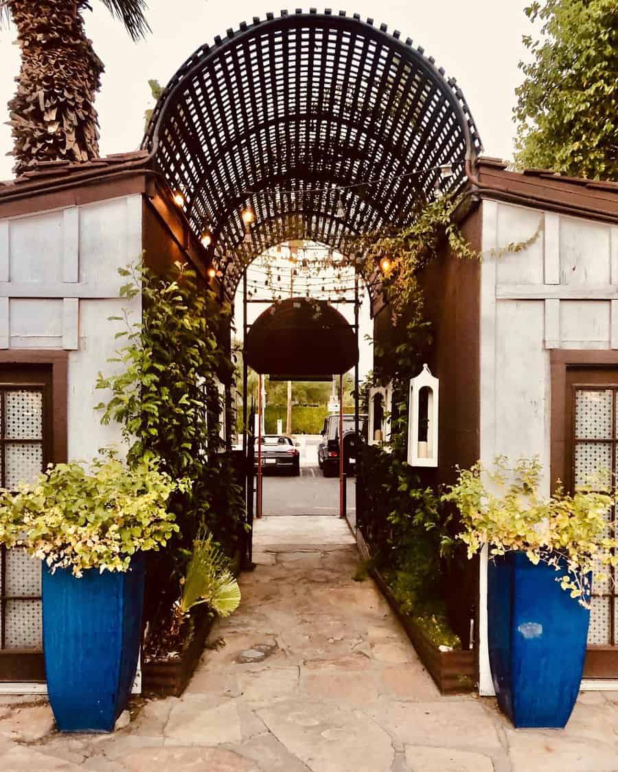 Urban walkway with decorative arch and planters