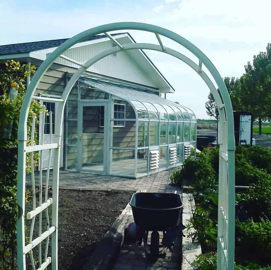 Arched entrance to a modern attached greenhouse