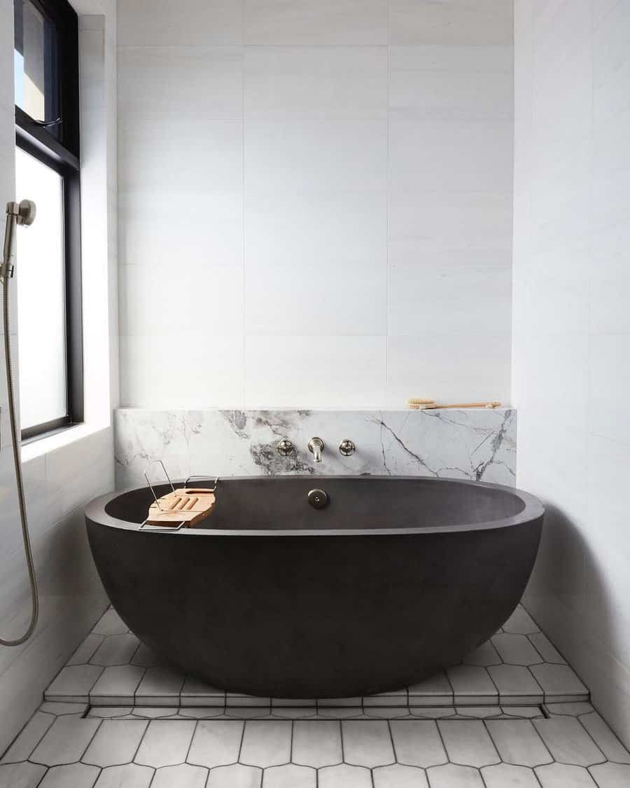 white bathroom with black bath tub