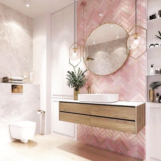 small bathroom with pink herringbone accent wall
