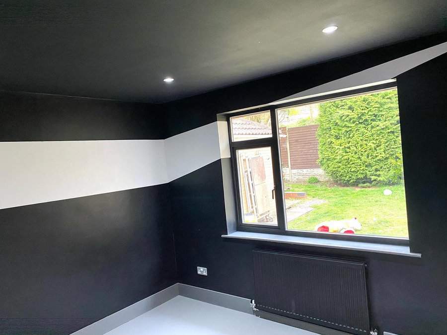 Room with black walls and garden view