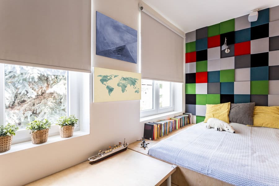 Colorful bedroom with map art and patterned wall