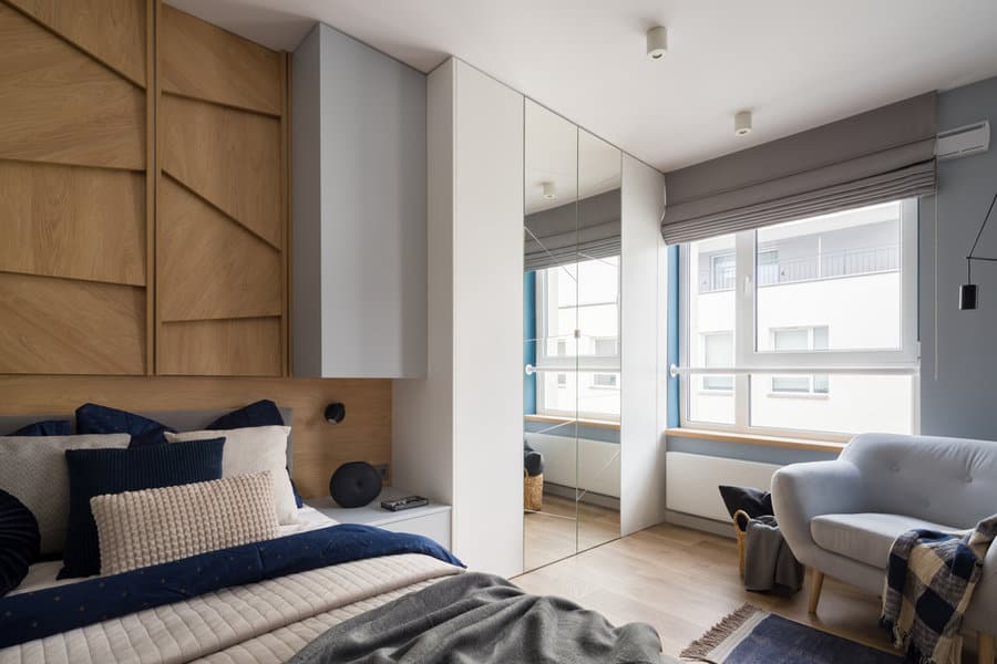 Modern bedroom with wood paneling and blue accents