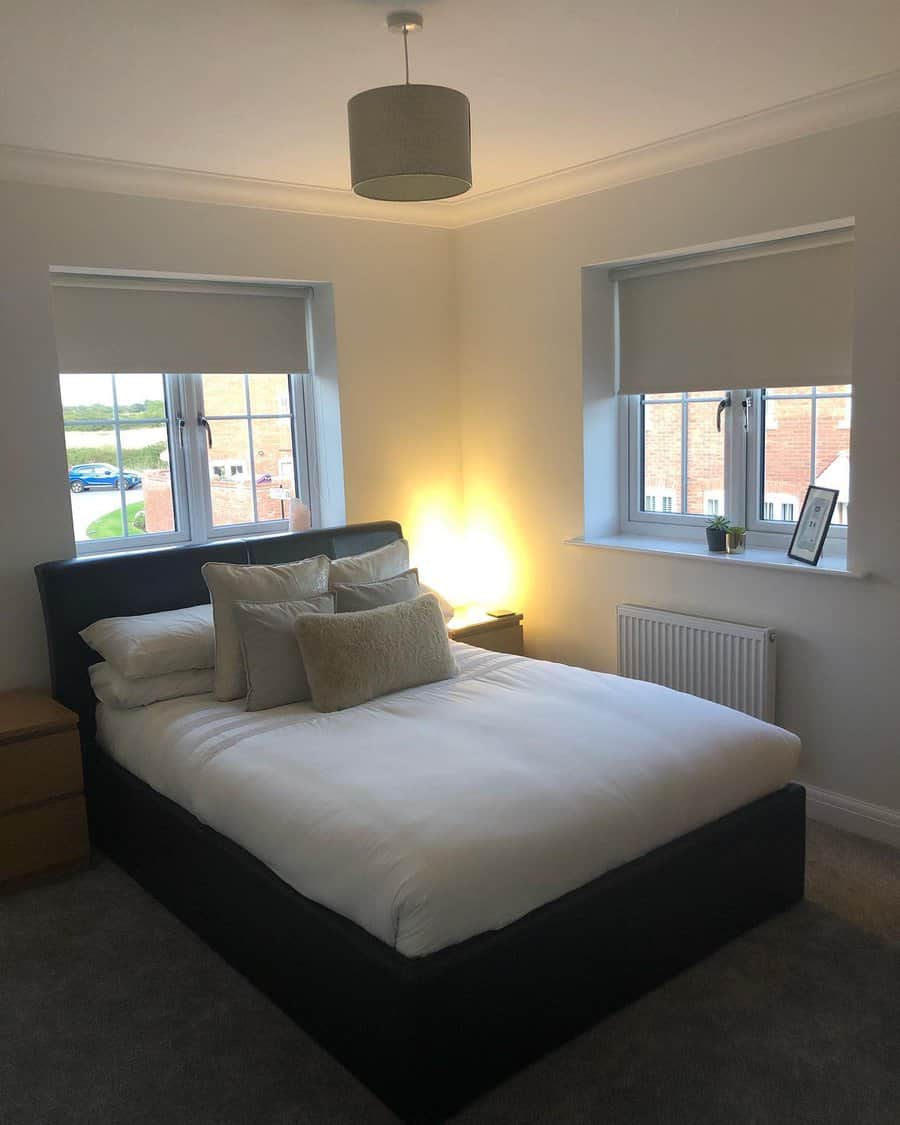 Minimalist bedroom with black bed and gray lamp shade