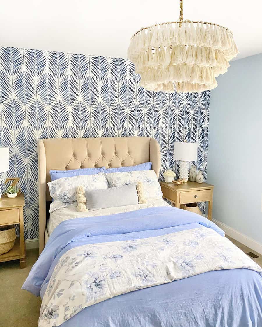 Bright bedroom with patterned wallpaper and tassel chandelier