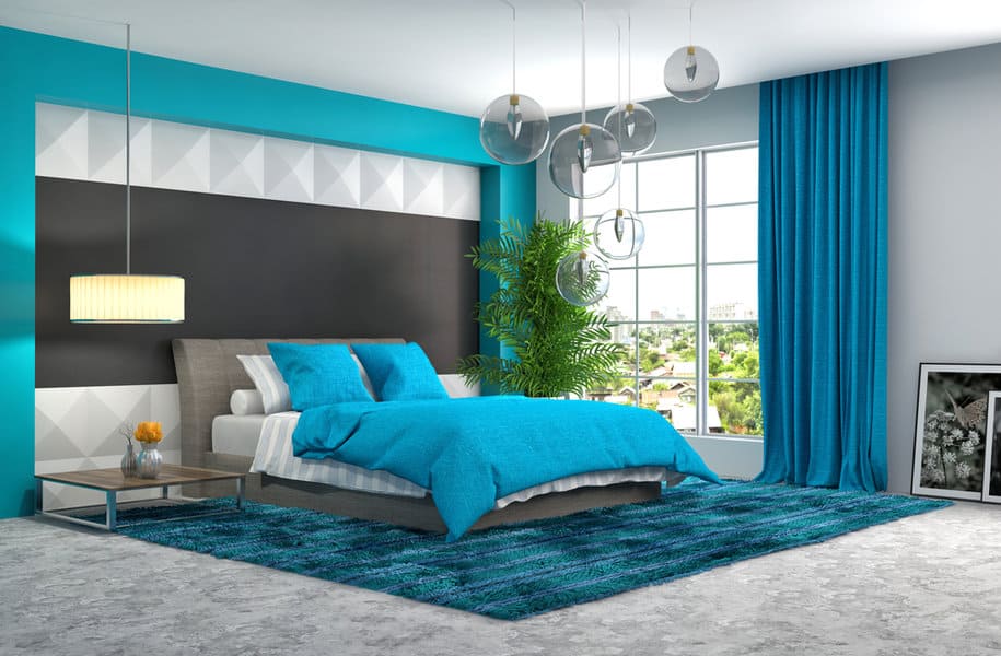 Vibrant bedroom with blue accents and geometric wall