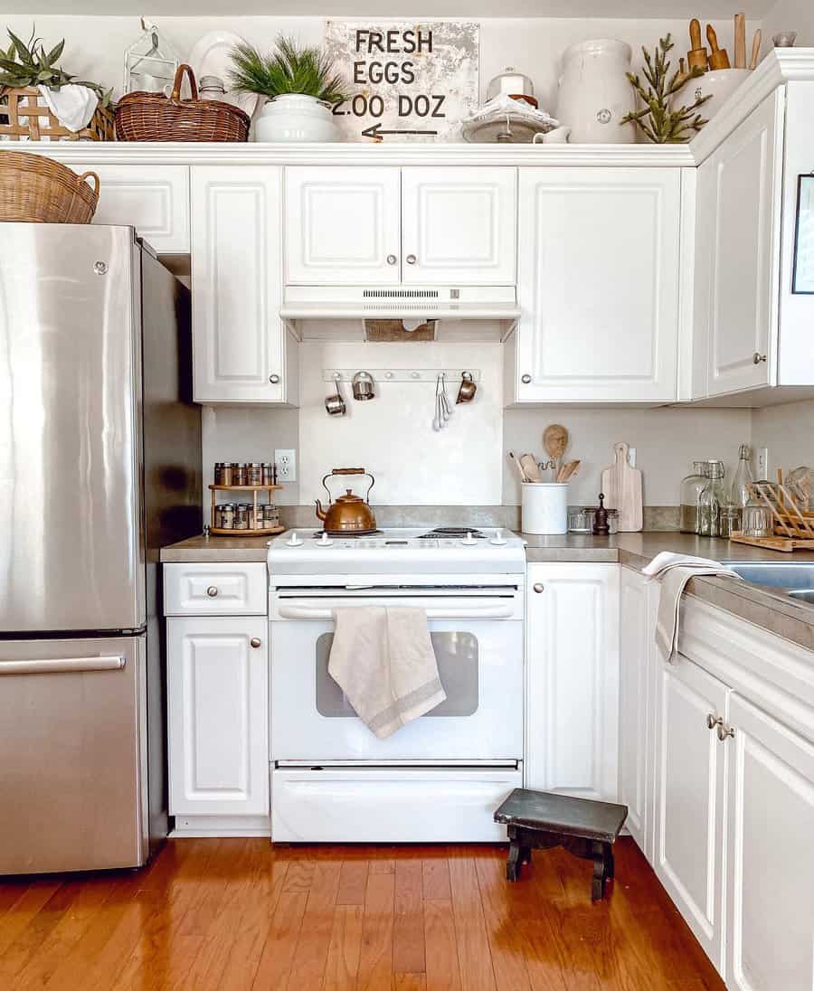 Small kitchen with sleek white cabinets