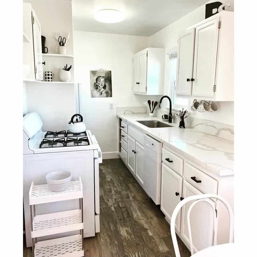 White kitchen with white cabinets and a white stove