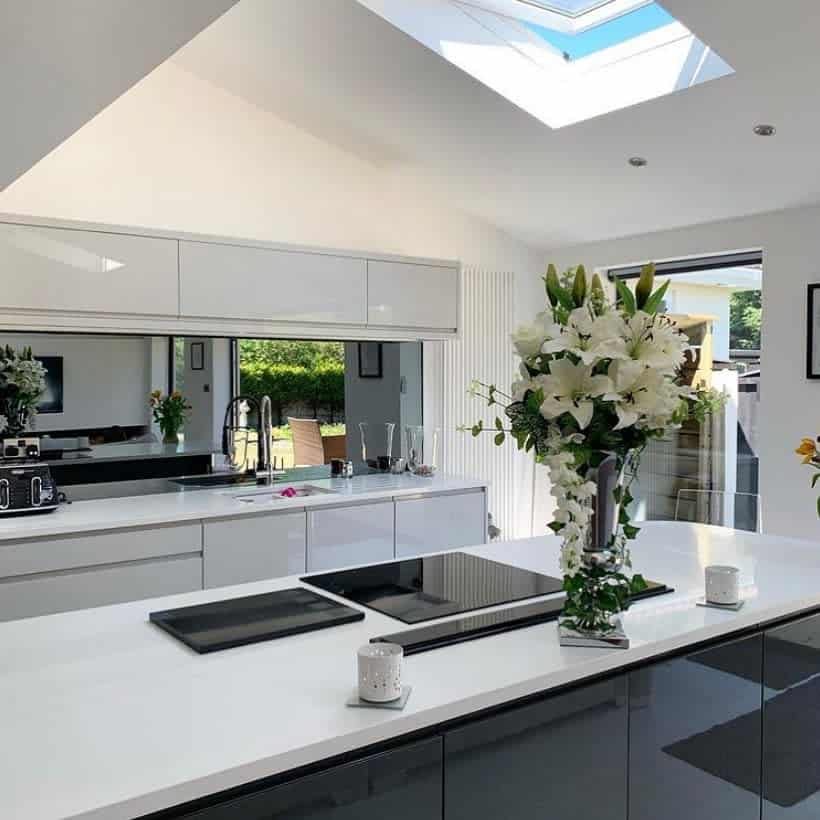 Sleek kitchen with skylight and floral centerpiece