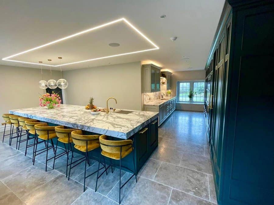 Luxury kitchen with LED ceiling and velvet stools