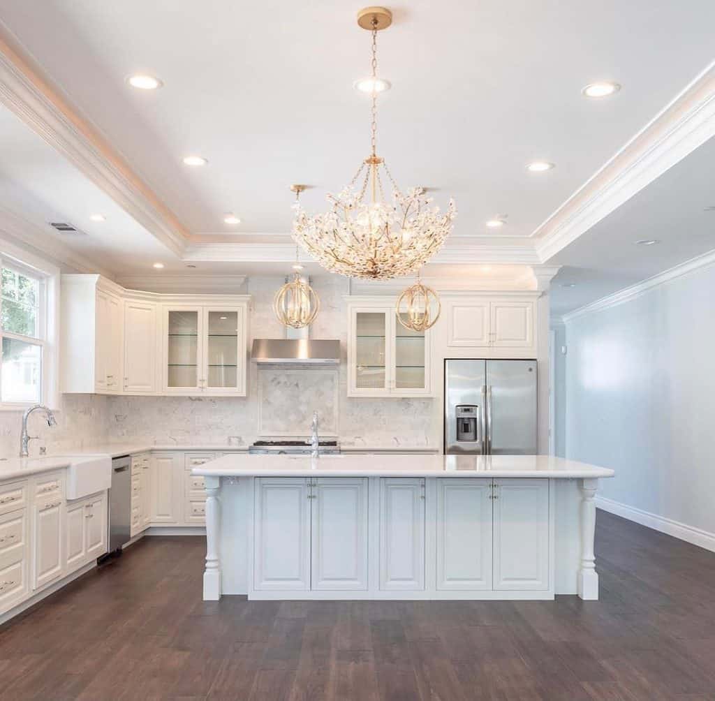 Opulent kitchen with crystal chandelier and marble island