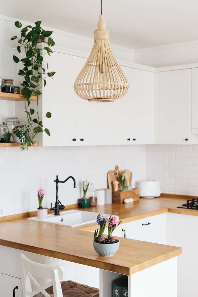 Bright white kitchen with wicker pendant