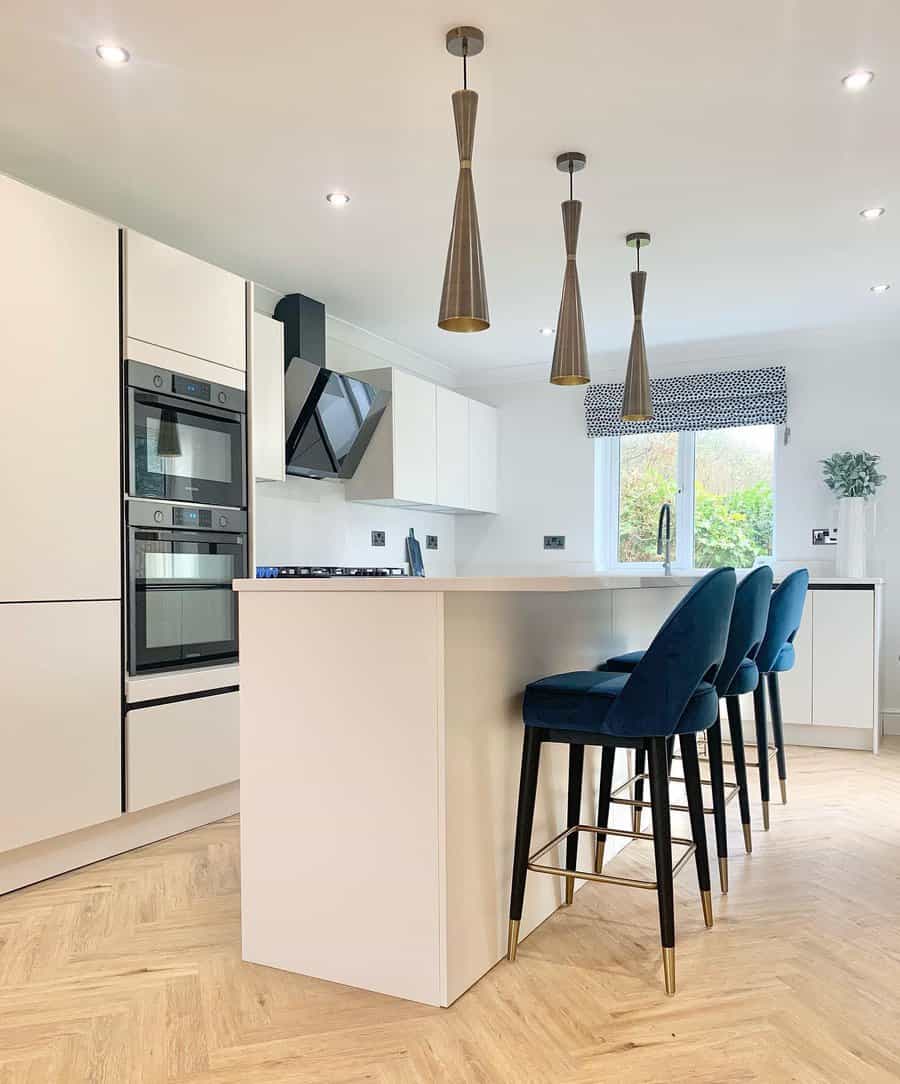 Bright white kitchen with conical pendants