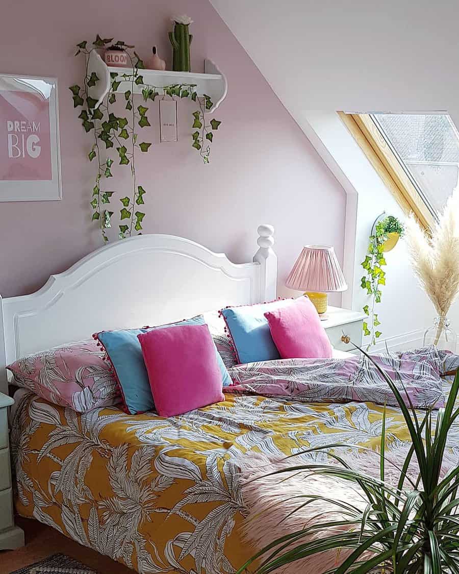 Bedroom with pink walls and colorful bedding