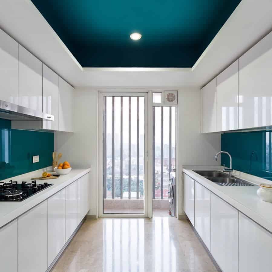 Kitchen with white cabinets and blue ceiling