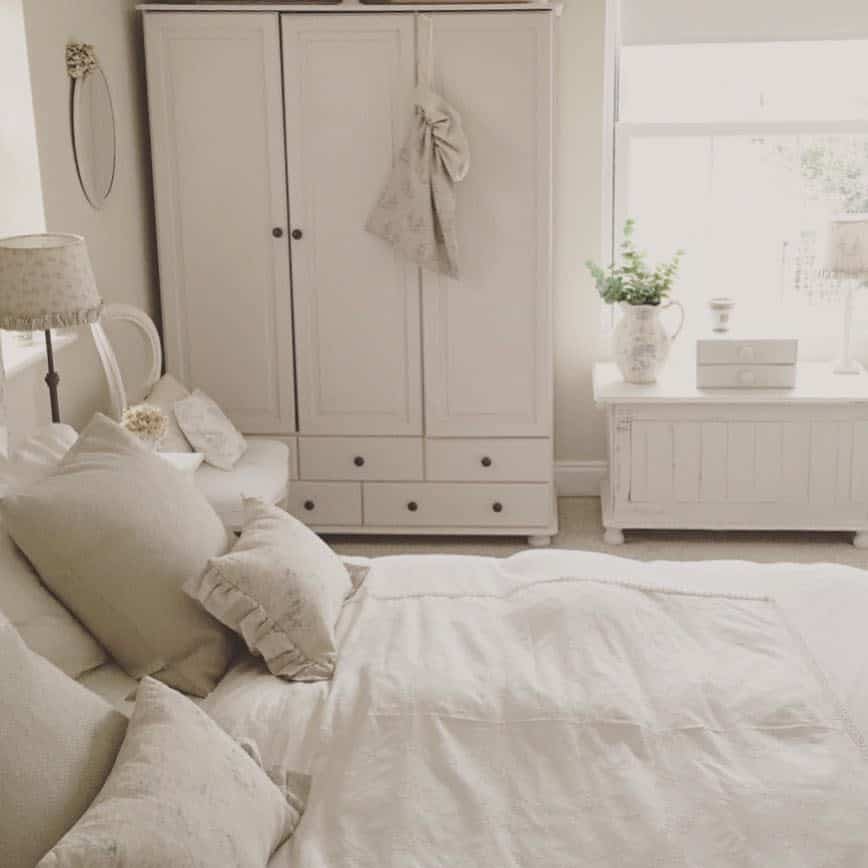 Minimalist white bedroom with vintage cabinet