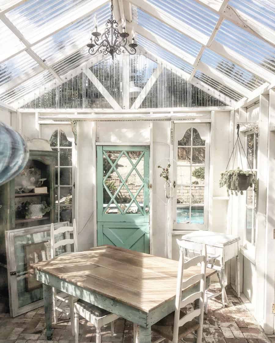 Vintage greenhouse interior with chandelier and turquoise door