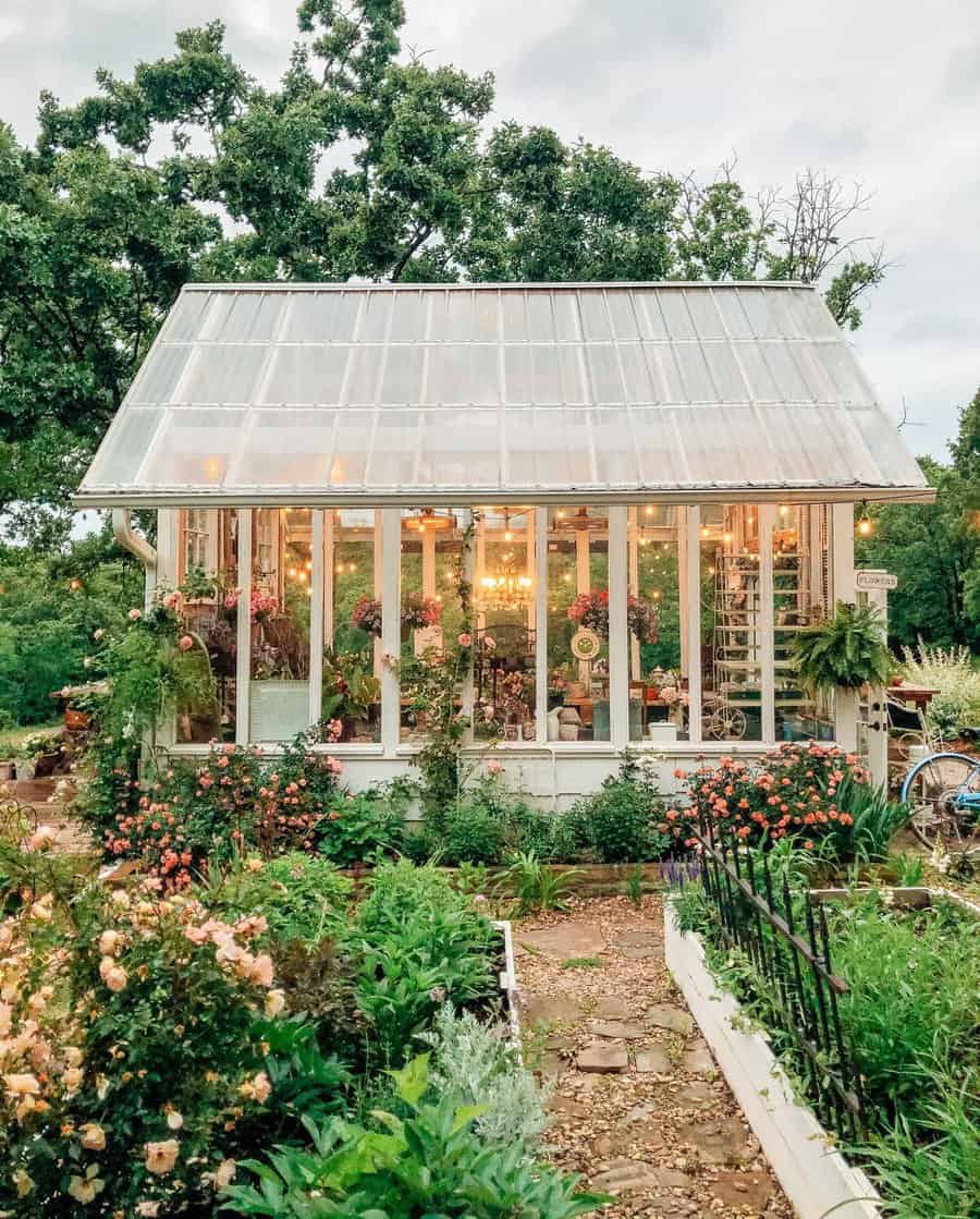 Idyllic greenhouse surrounded by lush gardens at dusk