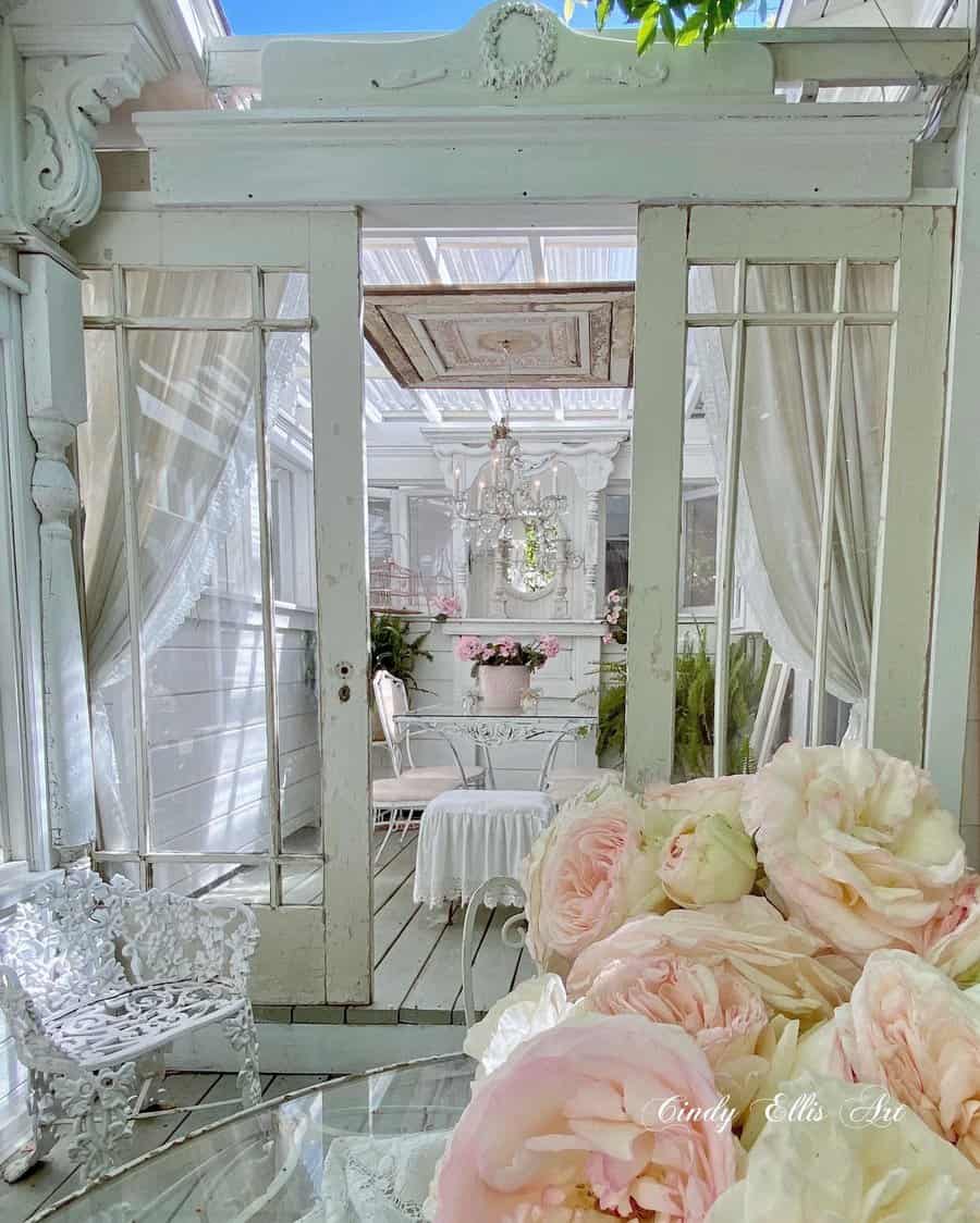 Shabby chic greenhouse interior with flowers and vintage decor