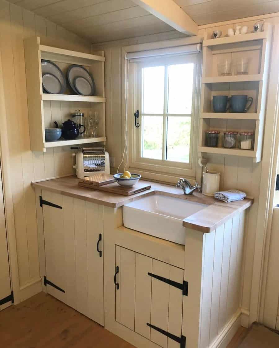 Cozy cottage kitchen with open shelving and farmhouse sink